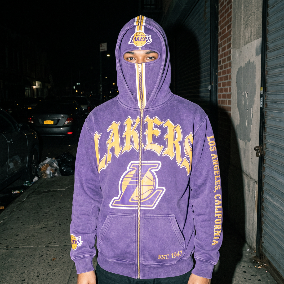Lakers HoopedHoodies hoodie zipped fully up over the face, crest on the panel, shot on the street at night